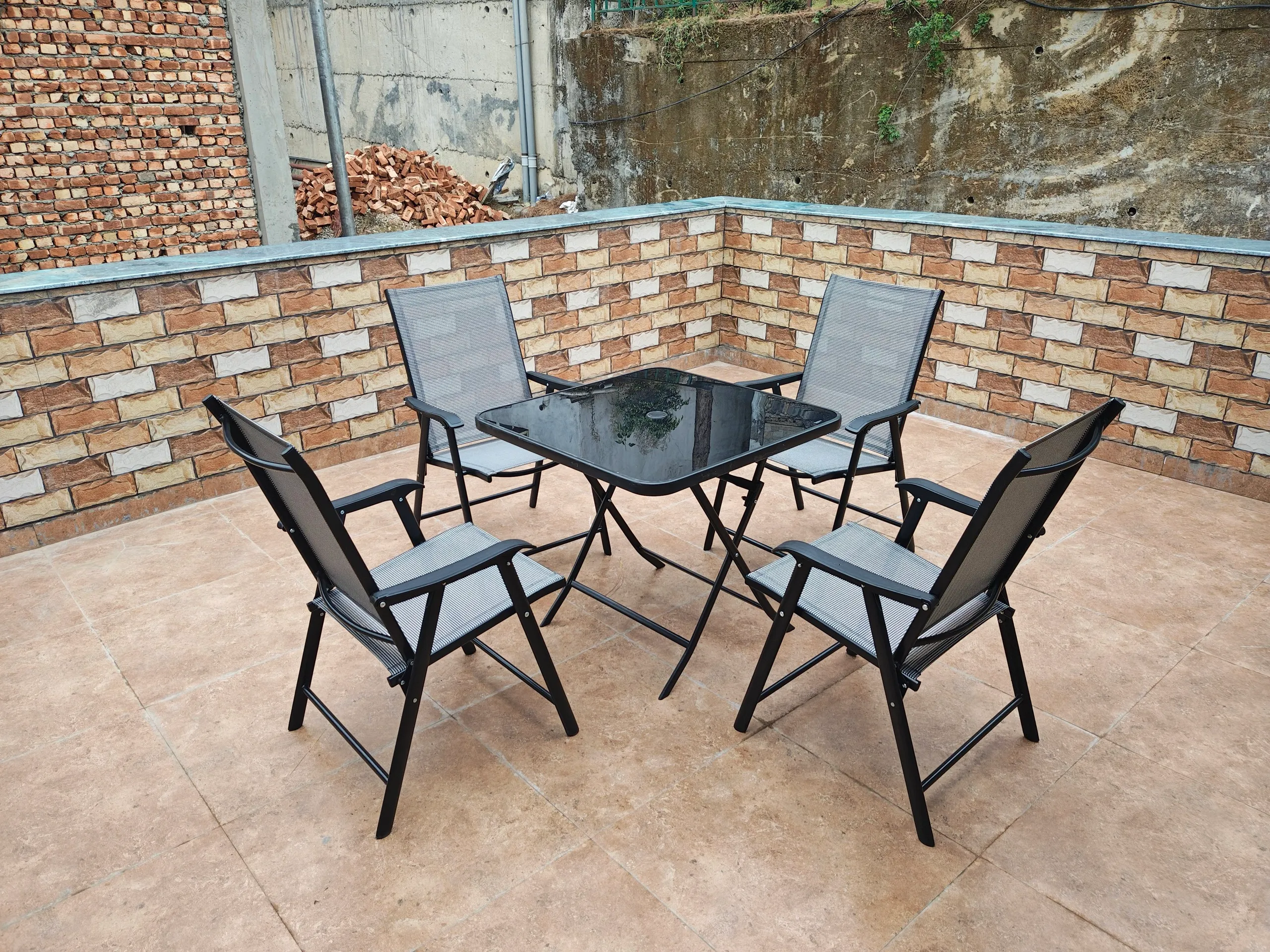 Outdoor patio dining set on stone tiles